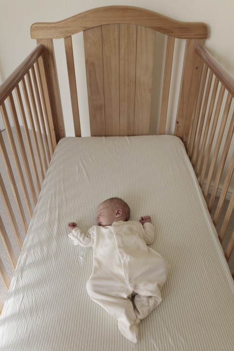 Baby lying on his back in a SafeSleep360° crib.