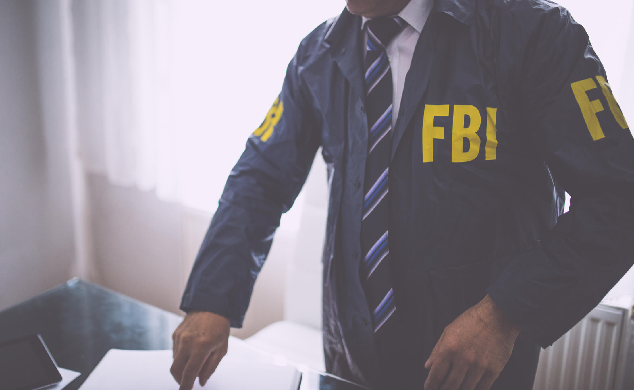 Person in jacket with the letters FBI printed on it